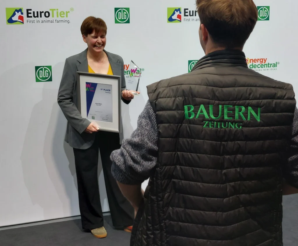 Jana Gäbert hält eine Urkunde und einen Preis in die Kamera